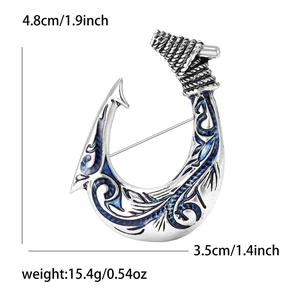 Detailed view of silver fish hook brooch with size specs 4.8cm height and 3.5cm width