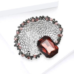 Vintage silver hollowed brooch with large reddish-brown gemstone and rhinestone accents
