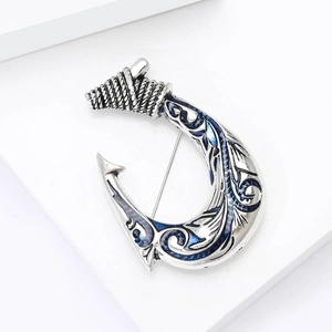 Retro silver alloy fish hook brooch with blue enamel tribal patterns and vintage finish
