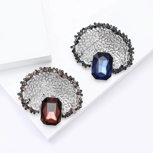 Vintage hollowed-out brooch with large emerald cut crystal and rhinestones in retro style