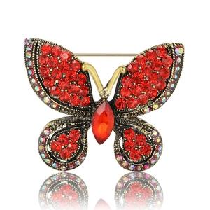 Exquisite butterfly brooch with red rhinestones and iridescent accents on gold alloy base