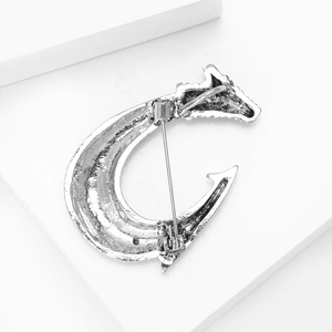 Detailed back view of the silver vintage fishhook brooch showing the pin mechanism and texture