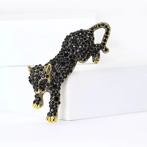 Detailed view of the sparkling black rhinestones and golden leopard brooch craftsmanship