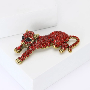 Vintage leopard brooch with red rhinestones on minimalist white stones display