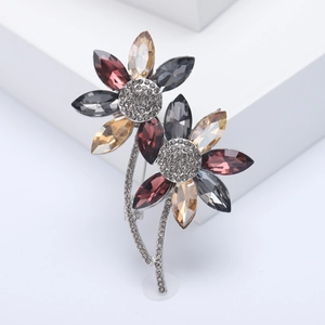 Detailed macro view of crystal flower brooch with champagne petals and silver metal stem