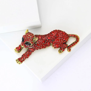 Macro view of leopard brooch with red rhinestones on a white geometric background