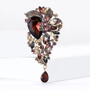 Elegant vintage crystal brooch with deep red teardrop stone and colorful rhinestones