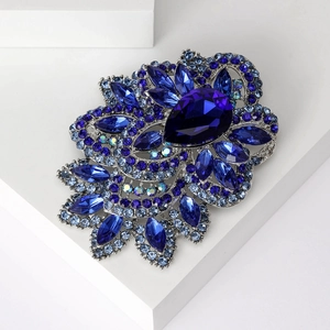 Exquisite flower brooch with large blue crystal and teardrop rhinestone on silver base