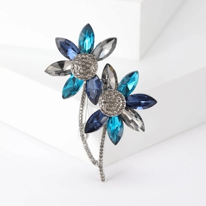 Elegant floral crystal brooch featuring deep blue petals and shimmering silver accents