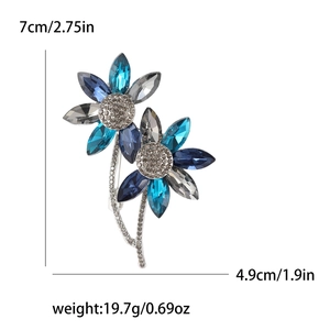 Elegant silver-toned crystal flower brooch with blue marquise gems and rhinestones