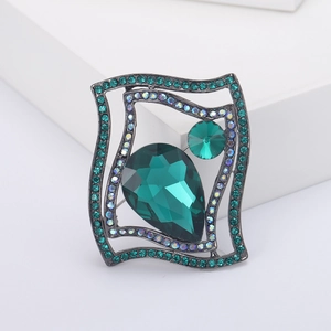 Elegant emerald green crystal brooch with sparkling rhinestones in a unique wavy design