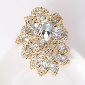 Close-up of luxury crystal glass brooch with teardrop rhinestone and gold alloy base