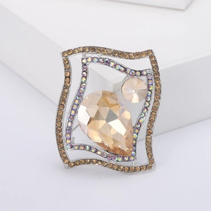 Macro detail of champagne crystal brooch with AB rhinestone borders on silver base
