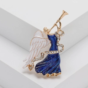 Golden angel brooch with deep blue enamel dress and sparkling crystals on white steps