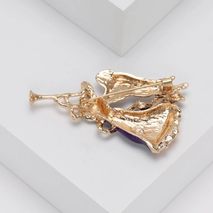 Macro view of golden metal brooch back showing secure pin fastener and angel wing detail