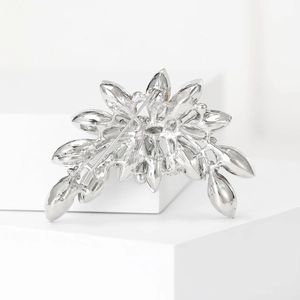 Detailed back view of silver floral brooch showing the secure pin fastener and metal finish