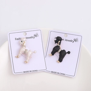 Detailed close-up of Poodle dog brooches with enamel finish and sparkling rhinestone collars