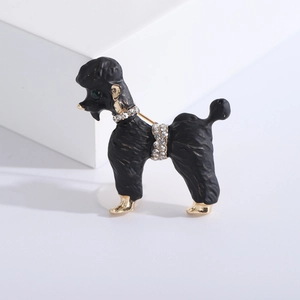Detail view of poodle brooch with black matte finish, rhinestones and green gem eye