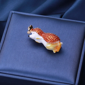 Détail macro d'une broche hérisson avec finition émail coloré sur une boîte bleue
