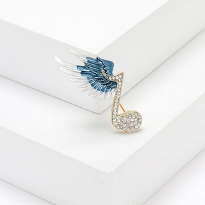 Elegant musical note wing brooch with blue gradient enamel and sparkling rhinestones