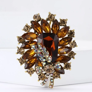 Macro detail of a vintage floral brooch with amber crystals and a bronze metallic bow
