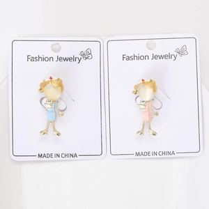 Detail view of cute nurse brooches with cat eye stone inlay on a fashion jewelry card