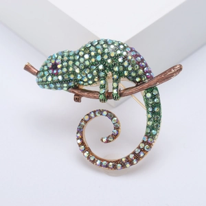 Exaggerated vintage chameleon brooch with colorful rhinestones on a brown branch