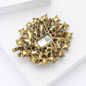 Detail view of the vintage gold alloy brooch back showing the secure safety pin clasp