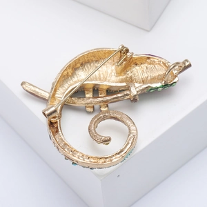 Detailed back view of a gold-plated chameleon brooch featuring a secure safety pin clasp