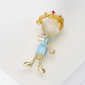 Detailed close-up of a cute nurse brooch with white opal head and gold-plated alloy