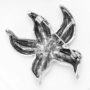 Detailed back view of a starfish lapel pin showing the secure rotating safety pin clasp