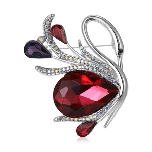 Elegant swan crystal brooch with red pear-shaped gemstone on polished silver base
