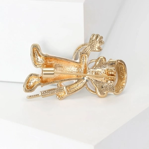 Golden doctor cartoon brooch pin with high gloss metallic finish on a white background