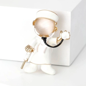 Cartoon male doctor brooch with white enamel, opal head, and gold stethoscope detail
