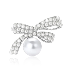 Elegant bow brooch with small pearls and large drop pearl on a polished silver metal base