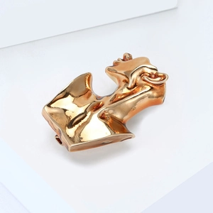Abstract torso sculpture brooch in polished gold finish for minimalist women's fashion