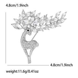 Detailed view of silver deer brooch with white rhinestones and crystal antlers