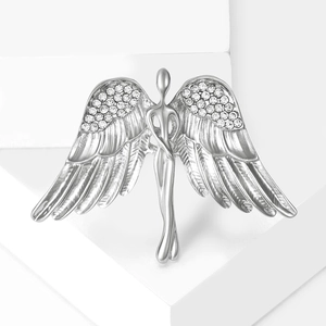 Detailed macro view of silver angel wing brooch with sparkling diamond accents
