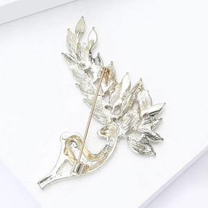Close-up of the silver brooch back showing the pin fastener and fine metal texture