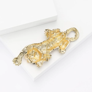 Détail du revers d'une broche guépard dorée avec fermoir à épingle et texture métallique