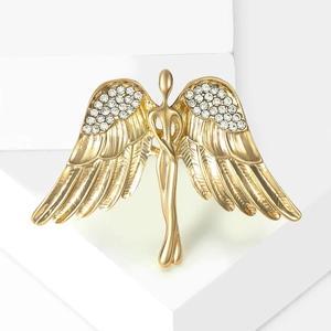 Detailed close-up of golden angel wing brooch with shimmering white zircons and relief
