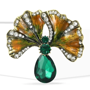 Elegant vintage gold ginkgo brooch with emerald green stones and white zircon accents