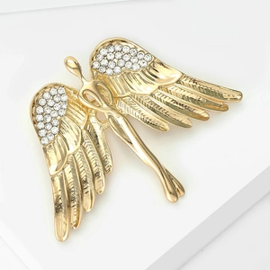 Detailed close-up of golden angel wing brooch with sparkling white rhinestones inlay