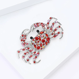 Close-up of crab brooch with red and AB rhinestones set in silver-tone alloy metal