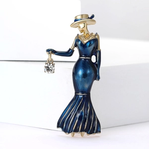 Detail of vintage lady brooch with blue enamel dress and sparkling rhinestone handbag