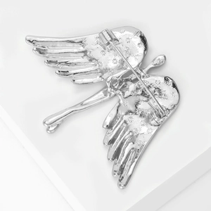 Detail of angel wing brooch back showing pin clasp and engraved star patterns