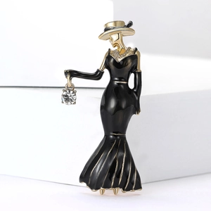 Detail of elegant enamel lady brooch with a dangling clear zircon on a gold base