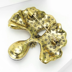 Macro detail of vintage gold brooch back featuring star texture and secure pin clasp