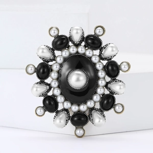 Vintage silver enamel brooch with large black gemstone and pearl halo design
