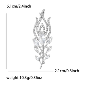 Silver-tone leaf brooch with sparkling crystals showing dimensions 6.1cm by 2.1cm